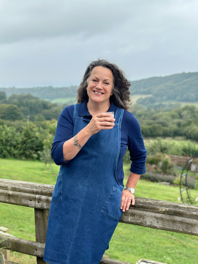 Photo of Co-Director Shann Jones at Welsh Farm drinking glass of kefir smoothie.